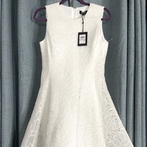 Ladies white DKNY cocktail dress. Rose textured pattern. Size 6. New with tags.